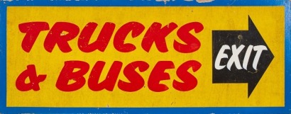 A Hand-Painted &lsquo;Trucks & Buses Exit&rsquo; Wooden Sign
