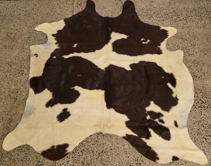 A Black And White Cow Hide Rug