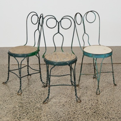 A Trio of Ornate Wrought Iron Garden Chairs