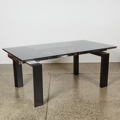 An Italian Style Extendable Dining Table with Smoked Glass Top and Metal and Wood body