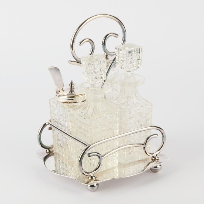 A Vintage Crystal Condiment Set in Silver Plate Carrier