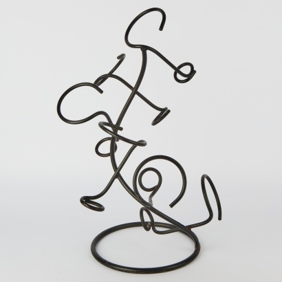 A Curved Wrought Iron Wine Rack