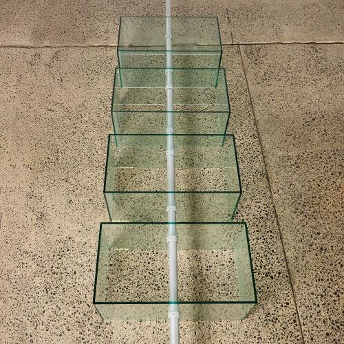 A Flood Standing Rotating Glass Display Shelving Unit