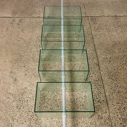 A Flood Standing Rotating Glass Display Shelving Unit