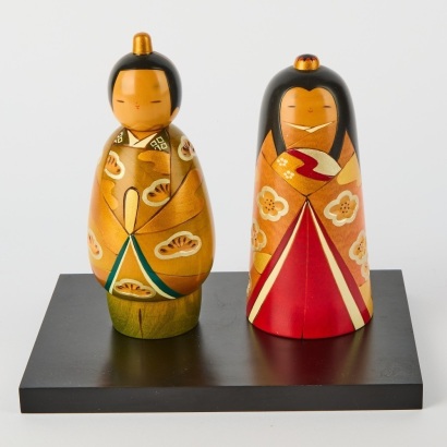 A Pair of Kokeshi Dolls On Stand
