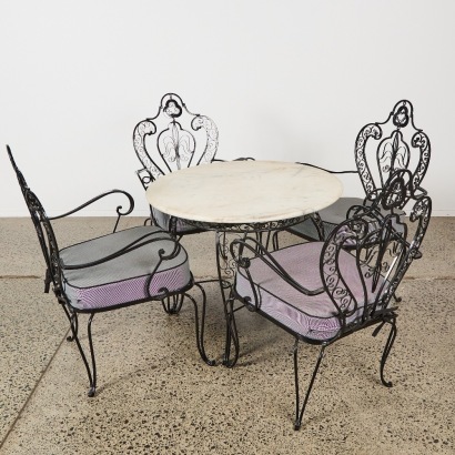 An Ornate Wrought Iron and Marble-Topped Table Outdoor Set