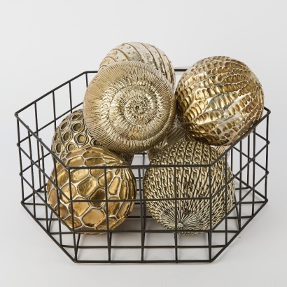A Collection of 7 Metal Finished Decorative Balls In A Wire Basket
