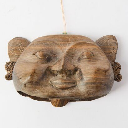 An Asian Carved Wooden Mask Wind Chime