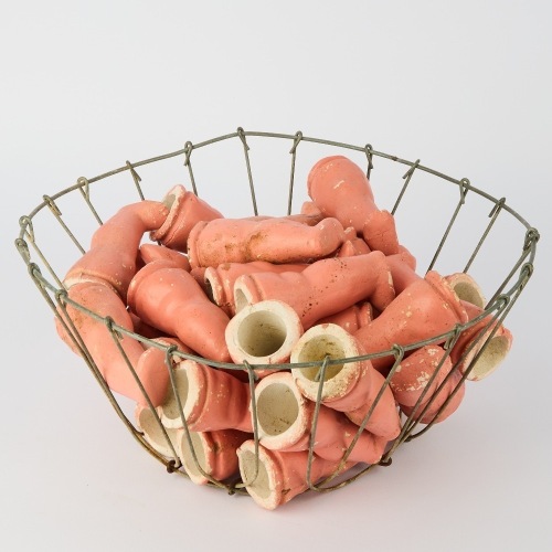 A Basket of Ceramic Dolls Legs