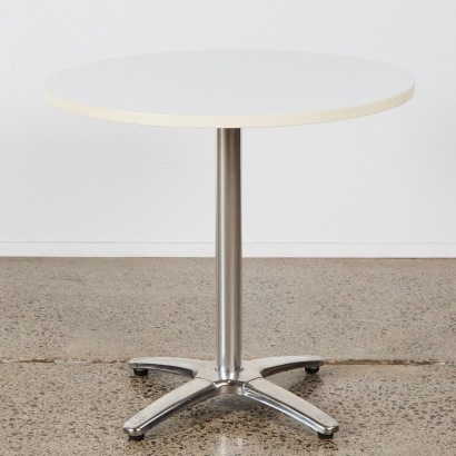 A White Top Circular Table with Chrome Base