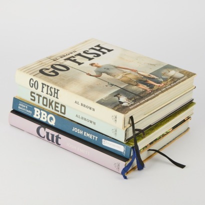 A collection of four Cookbooks Stoked and Go Fish by Al Brown and BBQ and Cut by Josh Emett
