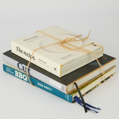 A collection of three Josh Emett Cookbooks. The Recipe, Cut and BBQ