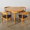 A Hans Olsen Roundette Style Dining Table With Four Nested Chairs