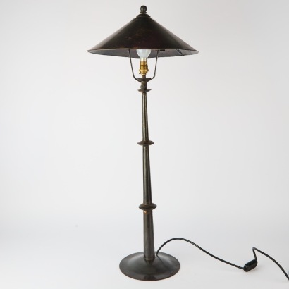 An Adjustable Black Metal Floor Lamp With Conical Shade