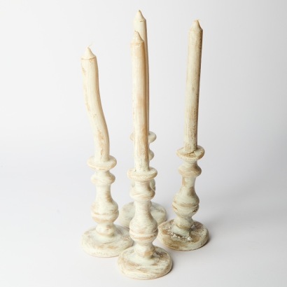 A Set of Four Moulded Antique Style Candles