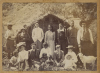 UNKNOWN PHOTOGRAPHER A Group portrait in front of a whare