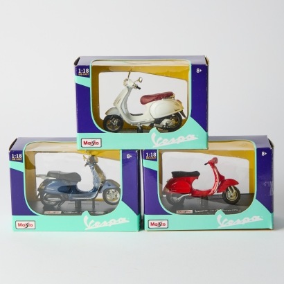A trio of Die Cast Vespa's Red, Black and White Boxed