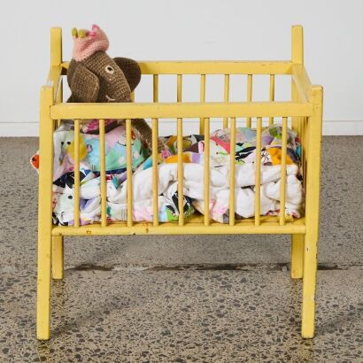 A Garagebuilt Play Cot with Knotted Elephant and Patchwork Blanket