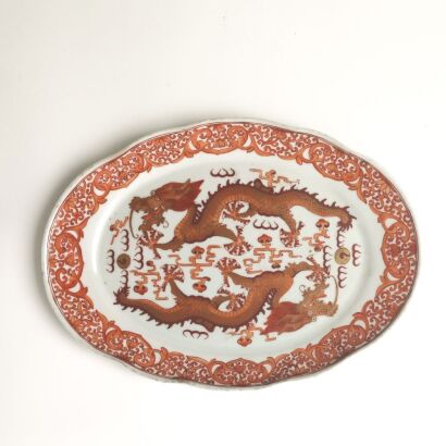 A Chinese Qing Dynasty Iron-Red 'Two Dragons Chasing a Flaming Pearl' Lobed Dish