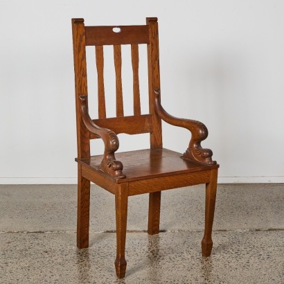 An Arts and Crafts Oak Chair with Dolphin Armrests