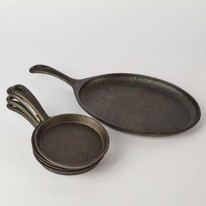 A set of five Cast Iron Frying Pans