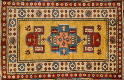 A Vintage Soft Yellow Red and Blue Turkish Rug