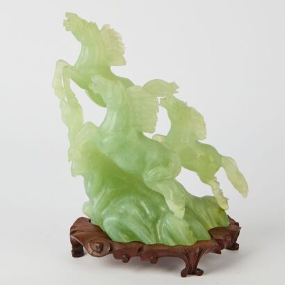 A Chinese Green Jade Carving of a Galloping Horse