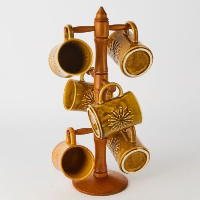 A Set of Six Crown Lynn Starburst Mugs on a Kauri Tree