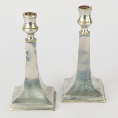 A Pair Of Polished Aluminum Candle Holders