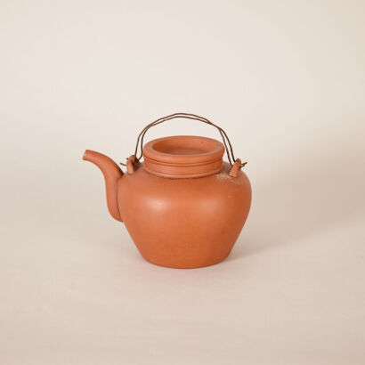 A Chinese Yixing Red Clay Teapot with Handle (Yi Hao Yuan Hu Mark)