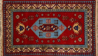 A Turkish Rug in Red, Pale Blue and Beige