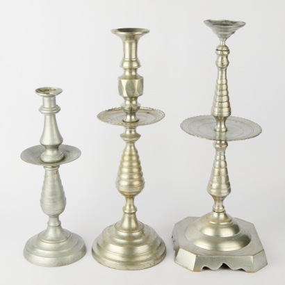 A Trio Of Large Metal Candle Holders