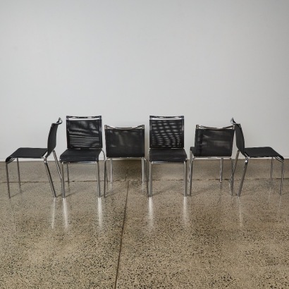 A Set of Six Chrome and Woven Vinyl Dining Chairs