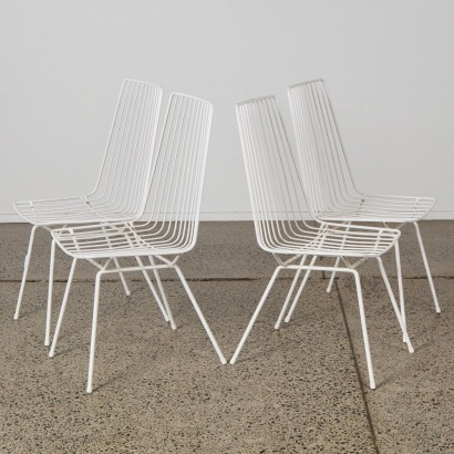 A Set of Four White Mid-Century Wire Chairs