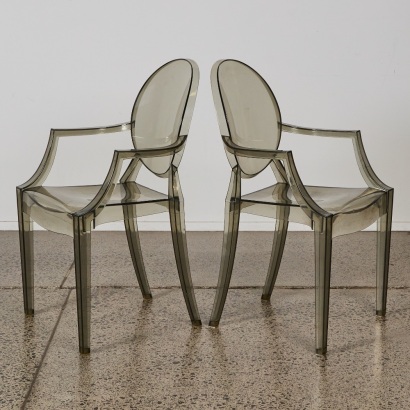 A Pair of Smoked Ghost Style Chairs