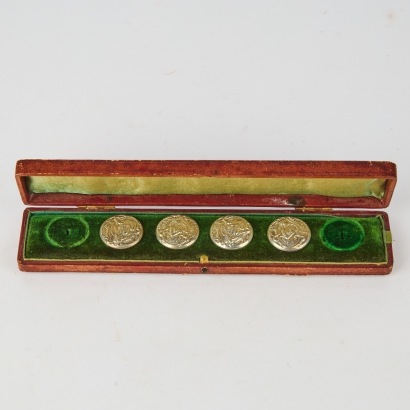 A Set of Four Silver Buttons in Case