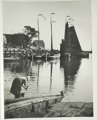"Woman with pails by canal, Netherlands"