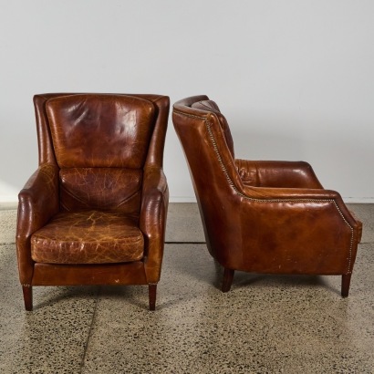A Pair of Aged Leather Armchairs