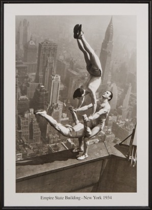 A Framed poster titled Acrobats Balance on top of the Empire State Building 1934