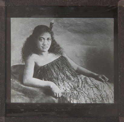 UNKNOWN PHOTOGRAPHER Unidentified wahene reclining on one arm with a feather in her hair and wearing a puipui
