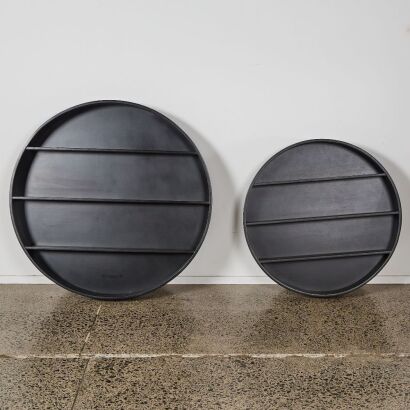 A Pair of Circular Black Timber Wall Shelves