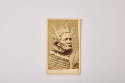 AMERICAN PHOTOGRAPHIC COMPANY (AUCKLAND) Unidentified Māori man with feathers in his hair and holding a paddle