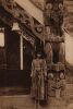 UNKNOWN PHOTOGRAPHER A French Catholic mission card with a young Māori woman standing next to the amo of Tawhitinui Wharenui