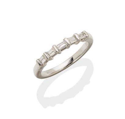 A diamond eternity band, the front section horizontally set with five baguette cut diamonds of estimated total weight 0.33 carats. Platinum and palladium. Size L.