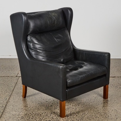 A Mid-Century Style Black Leather Wingback Chair