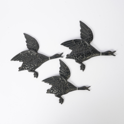 A Mid-Century Trio of Black Chalkware Flying Geese