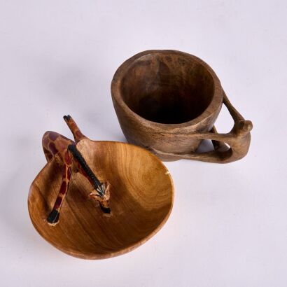 A couple of interesting hand carved Wooden Bowls. A parched Giraffe and a Man Handle