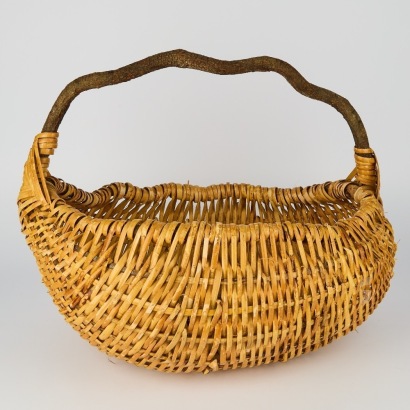 A Large Vintage Woven Basket with Organic Branch Handle