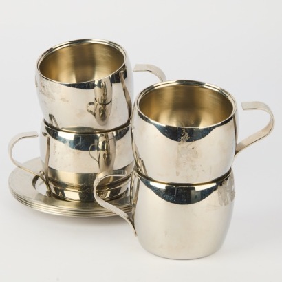 A Set of Four Metal Cups and Saucers