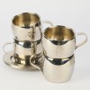 A Set of Four Metal Cups and Saucers
